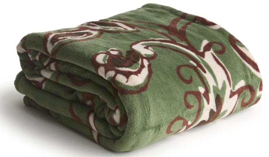 green floral blanket folded up