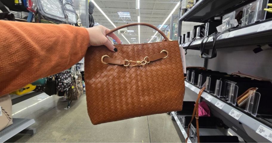 A woman holding a brown purse at Walmart 