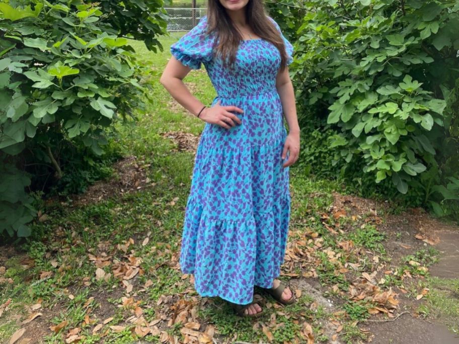 woman wearing Women's Prettygarden Boho Floral Print Dress in between bushes