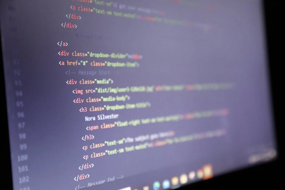 Illuminated HTML code displayed on a computer screen, close-up view. - affordable web hosting promo codes for bloggers