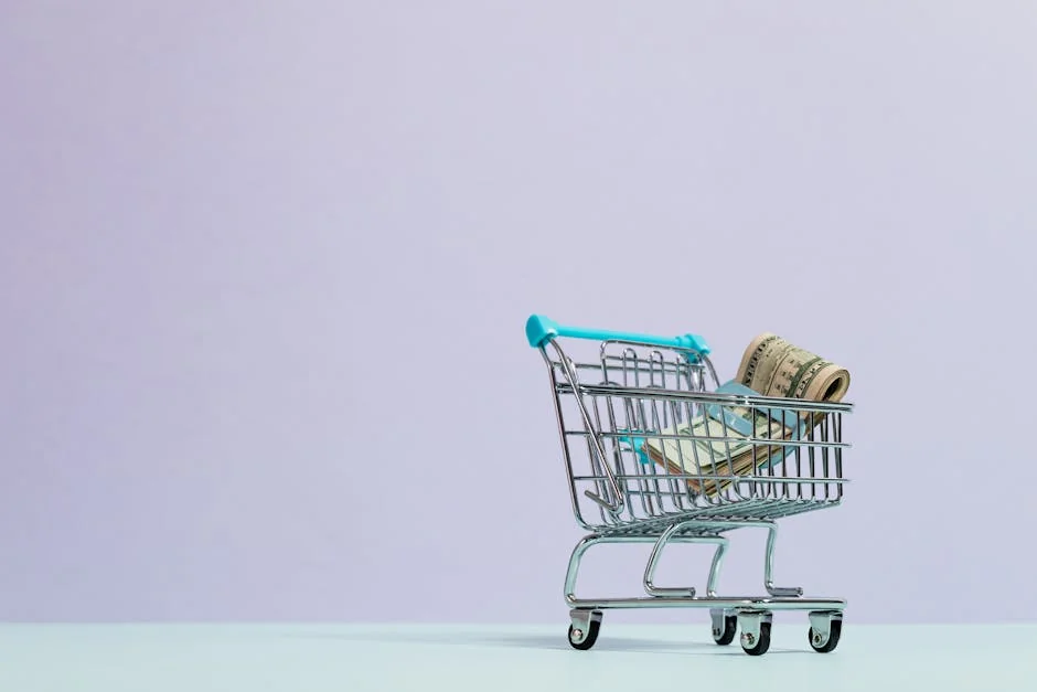 A close-up of a mini shopping cart with rolled cash on a pastel background. Ideal for finance and ecommerce themes. - shopping savings money - Best cashback apps to use with online coupons