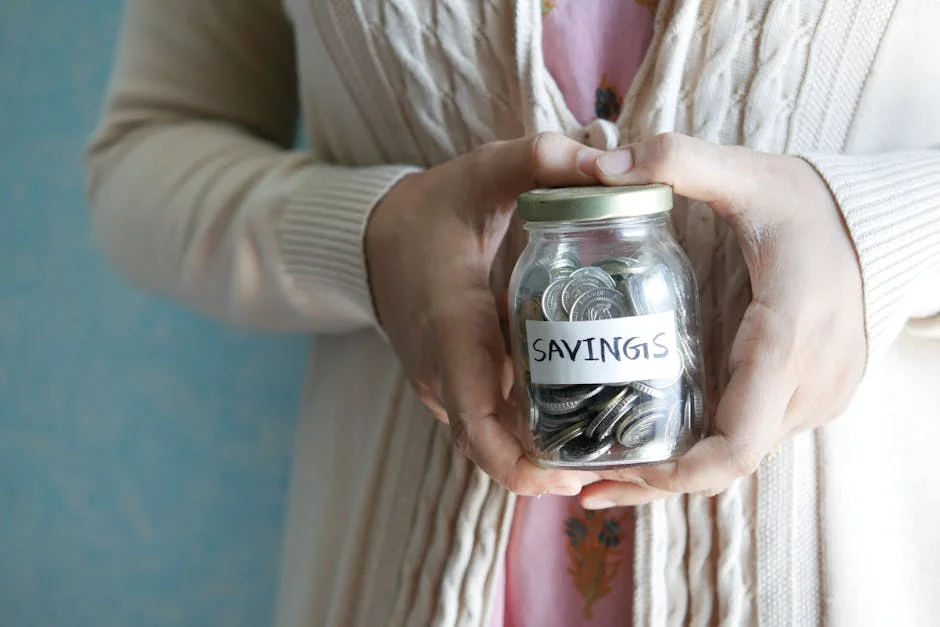 Woman holding a jar labeled 'savings' filled with coins, representing financial savings. - shopping savings money - Best cashback apps to use with online coupons