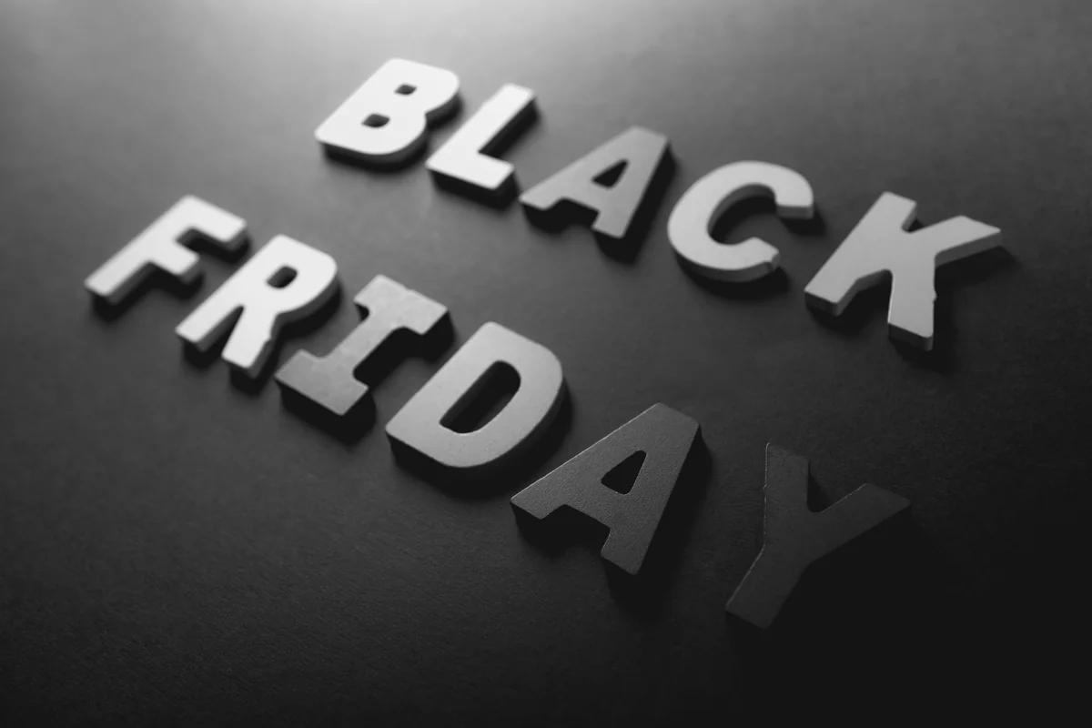 Black Friday inscription made of wooden letters on a black background. Black Friday concept. - black friday leaked ad scans and coupon codes