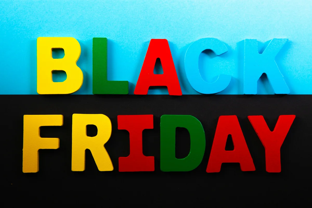 Black Friday word made of colorful wooden letters on black background. Black Friday concept. - black friday leaked ad scans and coupon codes