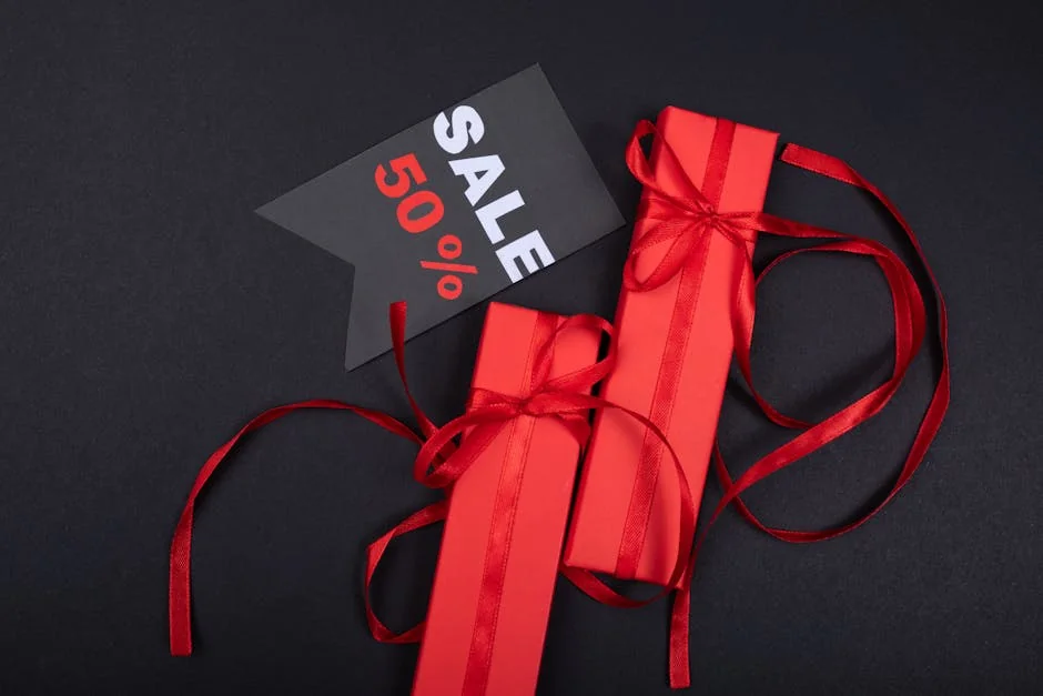 Red gift boxes with ribbons and 50% sale tag against black background. - how to combine manufacturer coupons with store sales