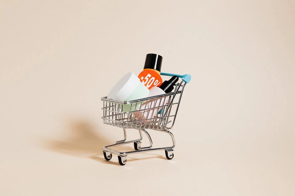 Mini shopping cart with cosmetics and a 50% discount sign on a neutral background. - how to combine manufacturer coupons with store sales