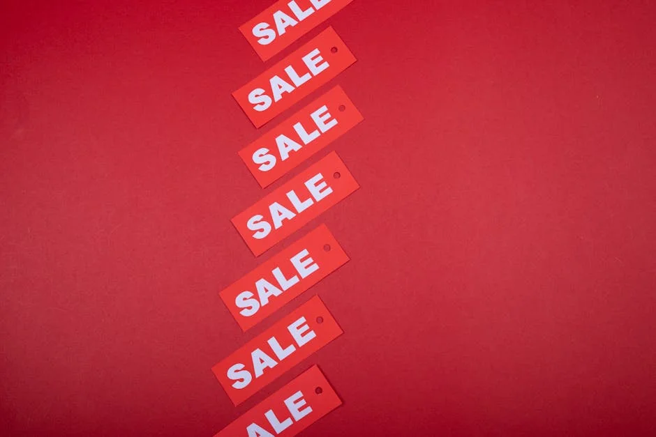 Red sale tags aligned diagonally on a red background, perfect for retail promotions. - how to combine manufacturer coupons with store sales