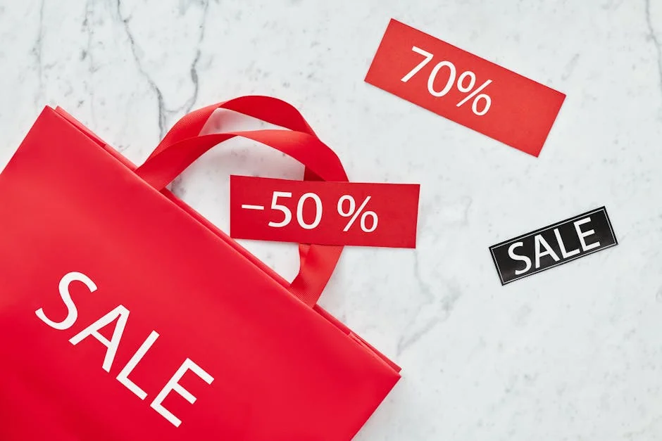 Red sale bag with 50% and 70% discount tags on marble background, perfect for retail promotions. - ecofriendly brand discounts and sustainable deals