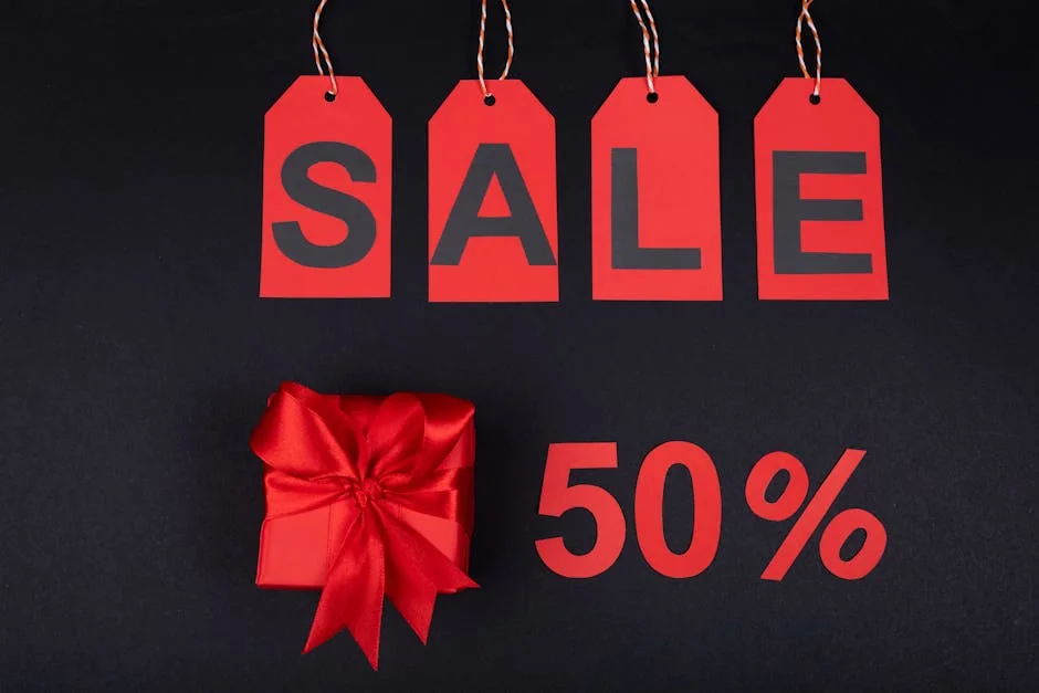 Red gift box next to sale tags and 50% sign on black background, ideal for promotions. - ecofriendly brand discounts and sustainable deals