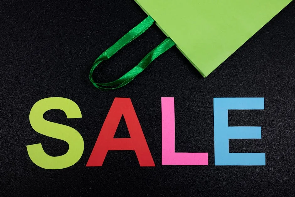 Close-up of colorful SALE letters on black background with green shopping bag. - ecofriendly brand discounts and sustainable deals