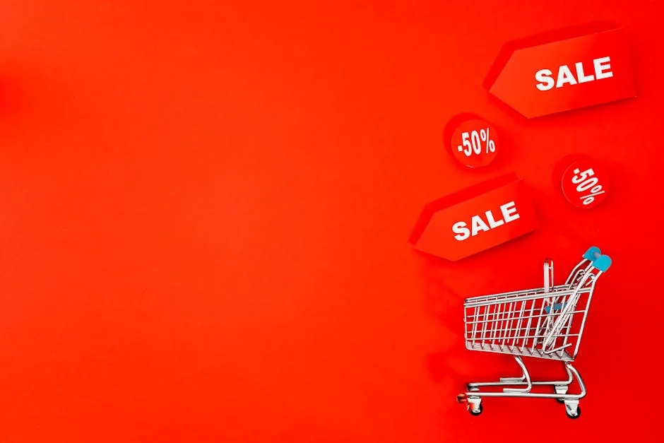 Shopping cart with sale tags on vibrant red backdrop promoting discounts. - ecofriendly brand discounts and sustainable deals