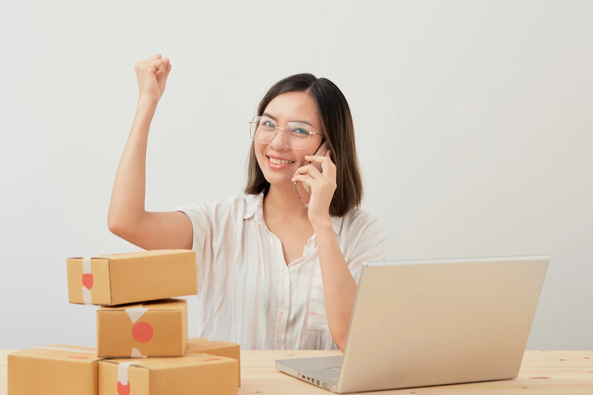 a woman sitting in front of a laptop computer - how to get free shipping on international orders