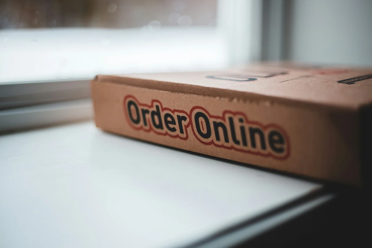orange and white box on white table - how to get free shipping on international orders