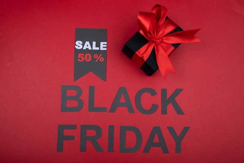 Black Friday sale banner with 50% off tag and gift box wrapped with red ribbon on red background. - limited time luxury fashion sales online