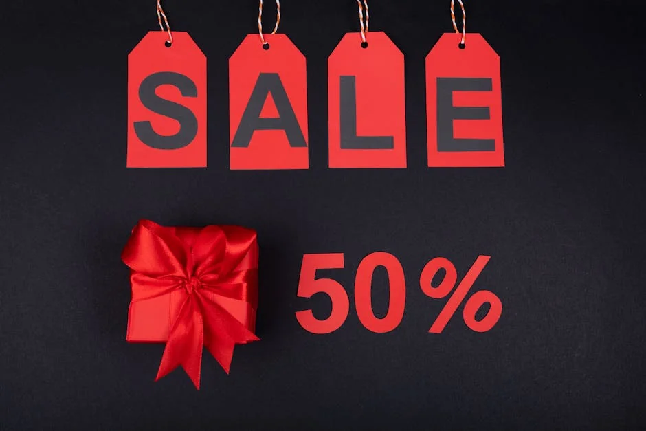 Red sale tags and gift box on black background emphasizing 50% discount for promotions. - limited time luxury fashion sales online