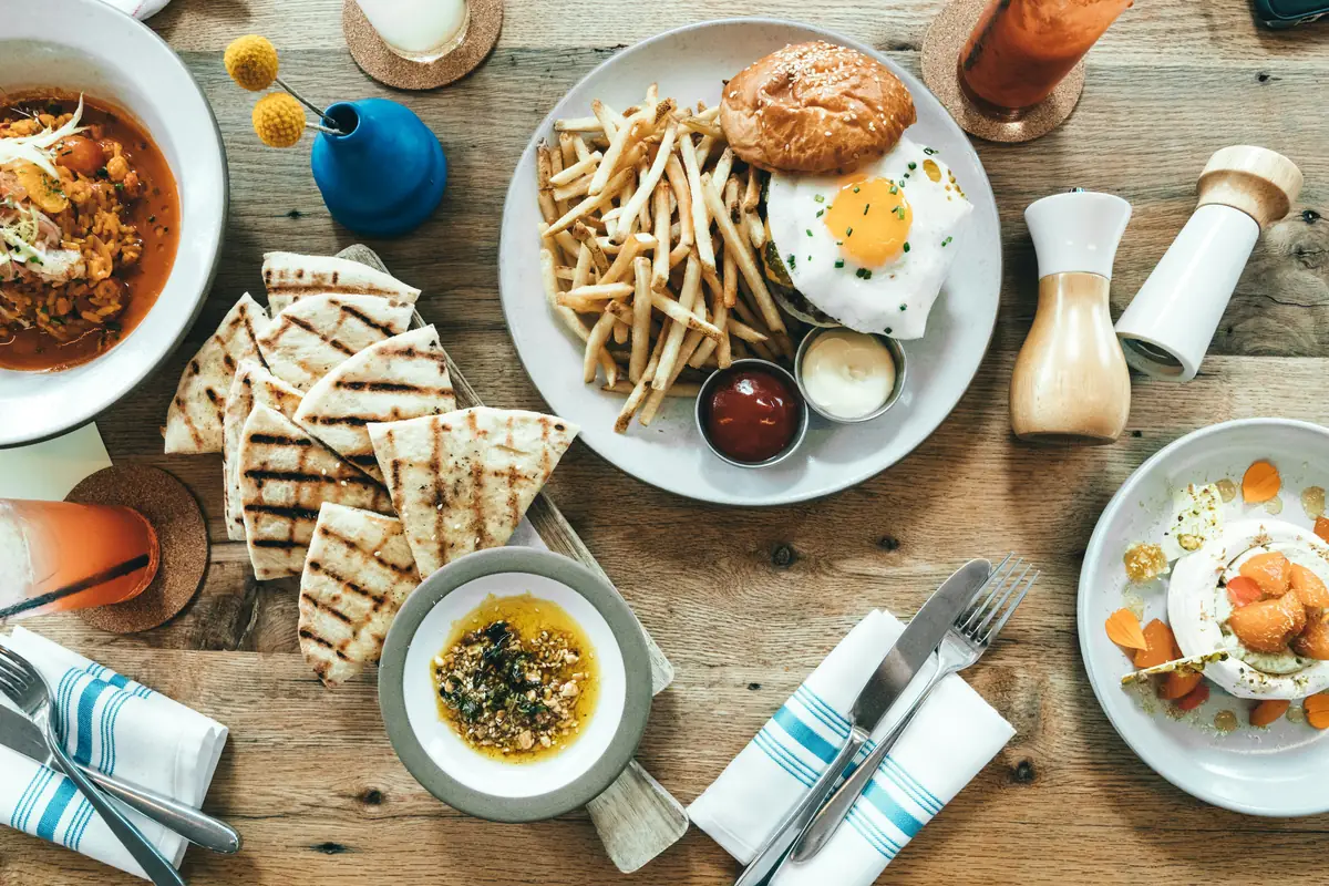 food lot near table decors in brown wooden table close-up photography - local restaurant coupons and dining out deals