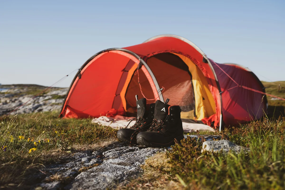 red dome tent on green grass field during daytime - outdoor camping gear deals and hiking equipment sales