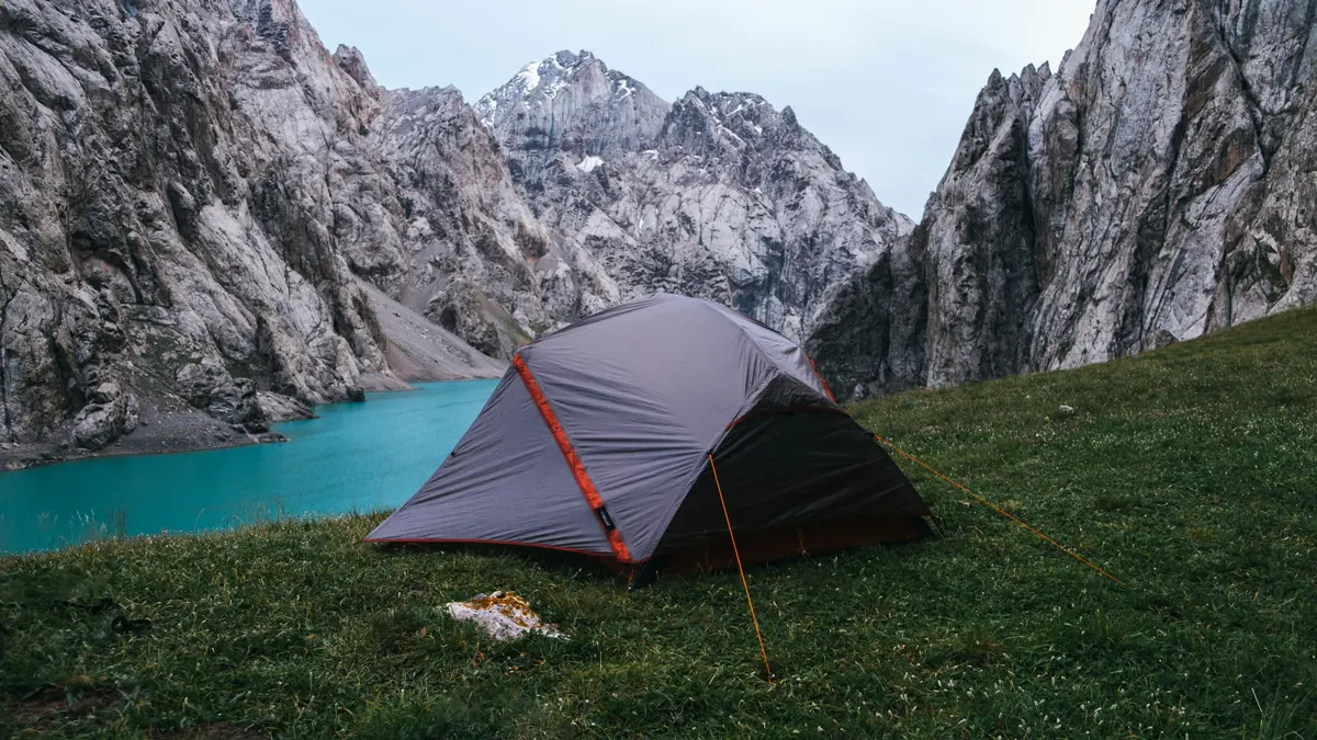 a tent pitched up on the side of a mountain - outdoor camping gear deals and hiking equipment sales