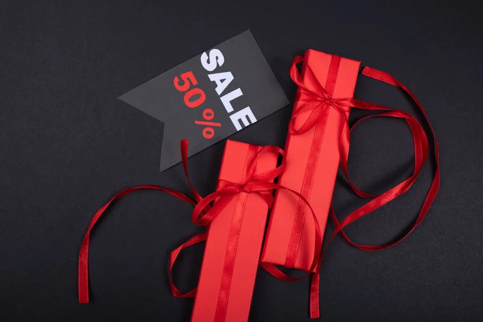 Red gift boxes with ribbons and 50% sale tag against black background. - photo printing coupons and personalized gift deals