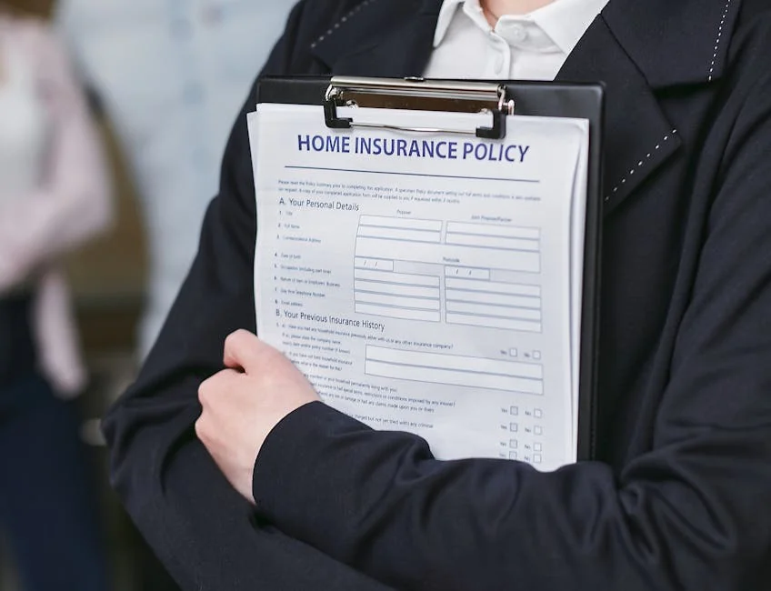 Close-up of a person holding a home insurance policy on a clipboard, captured indoors. - financial protection document - Save money on car insurance with exclusive codes