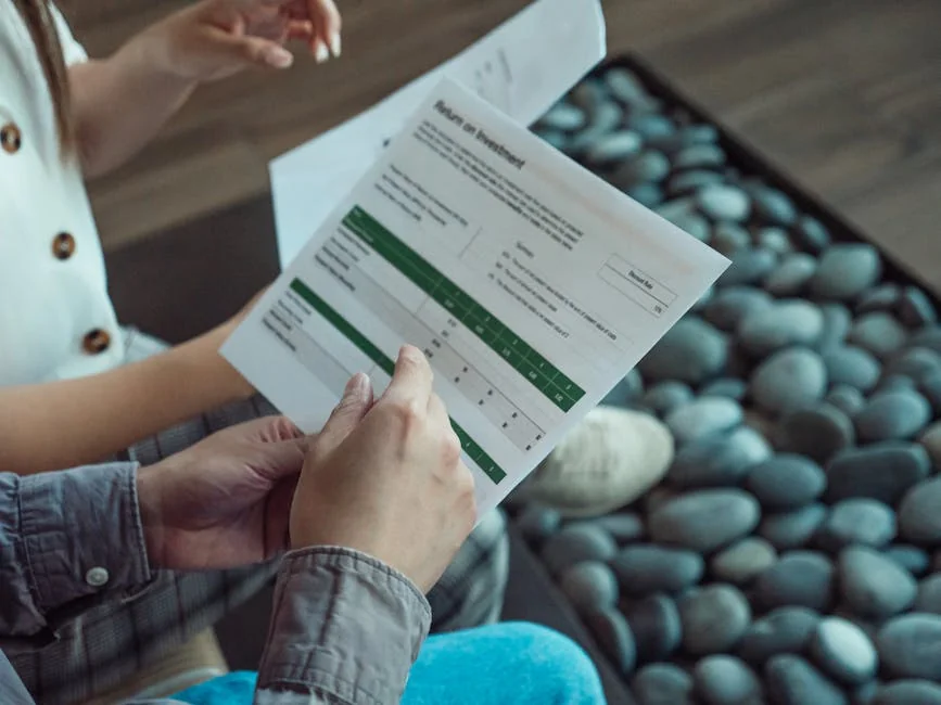 Two people discussing a financial document showing return on investment data. - financial protection document - Save money on car insurance with exclusive codes
