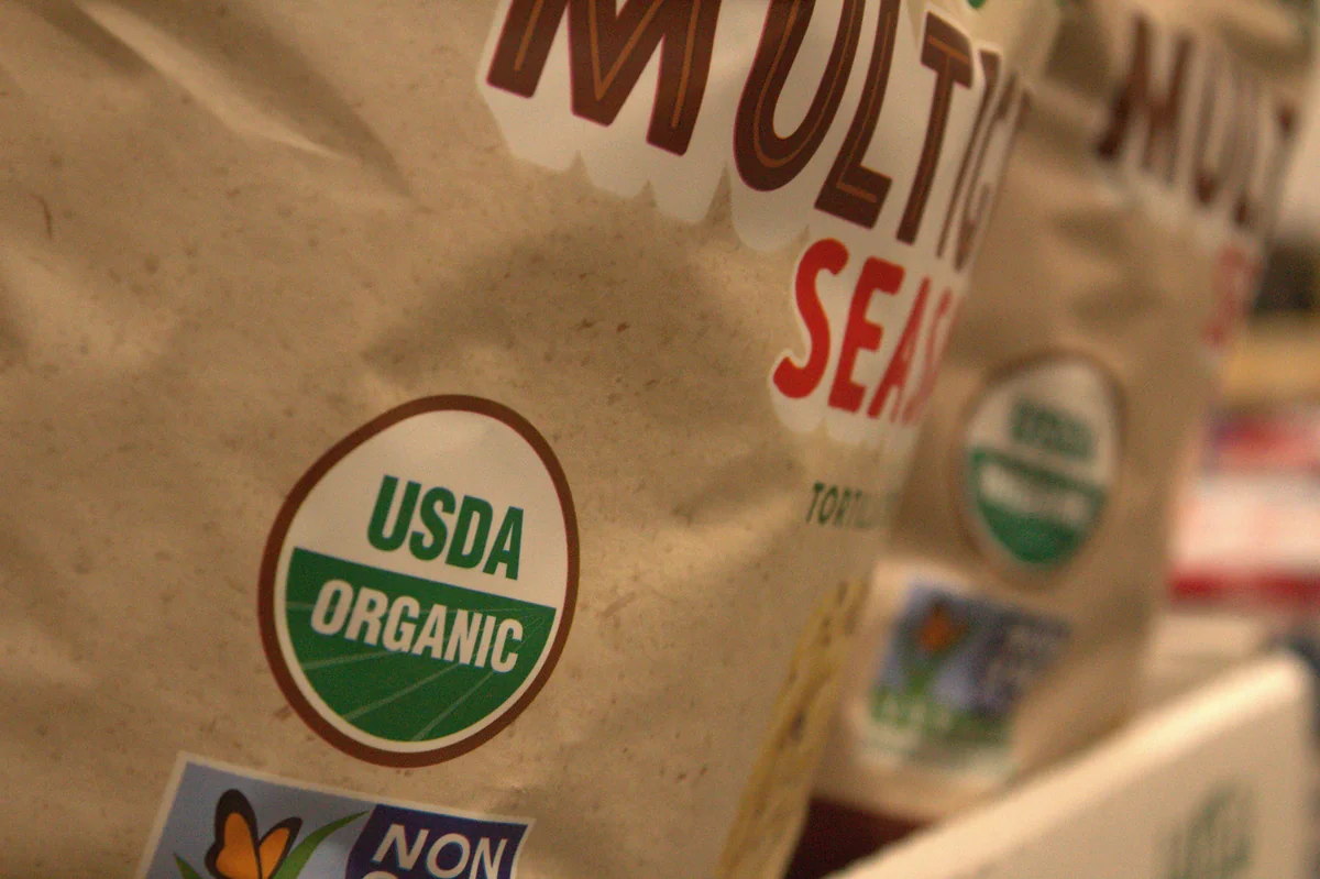 A close up of a bag of organic food - how to save money on organic groceries with coupons