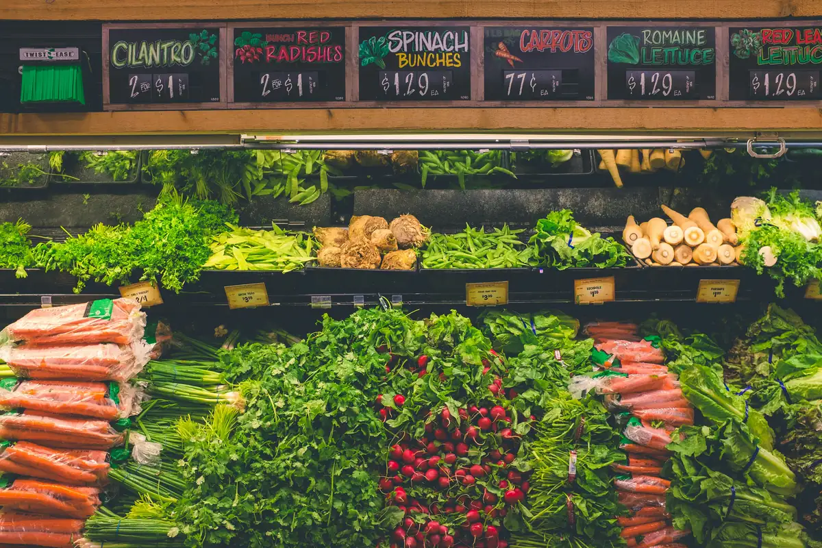 vegetable stand - how to save money on organic groceries with coupons