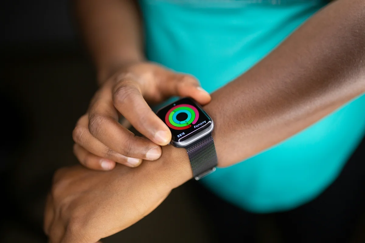 Woman using her Apple Watch - smart watch and wearable tech promo codes 2026