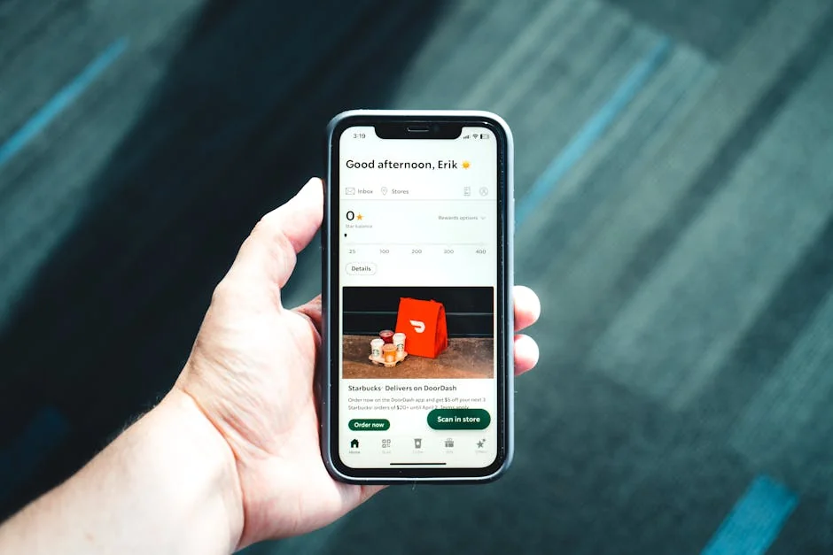 Close-up of a smartphone with a delivery app interface in a person's hand, emphasizing modern e-commerce. - subscription renewal discounts for streaming services