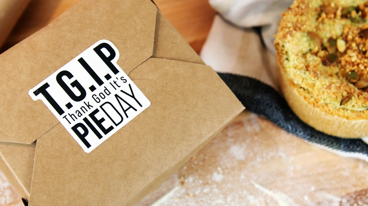 Die cut sticker applied to seal a cardboard box containing custom pies - top rated meal kit delivery service discounts