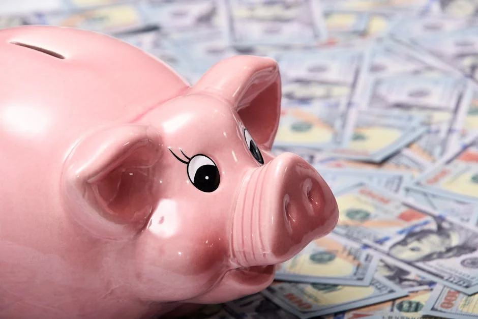 Close-up image of a shiny pink piggy bank surrounded by US hundred dollar bills, symbolizing savings and finance. - piggy bank money - How to use digital coupons at checkout for savings