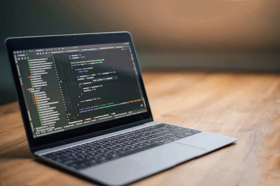 Laptop displaying software code on a wooden table, ideal for tech and programming themes. - verified amazon promo codes for electronics